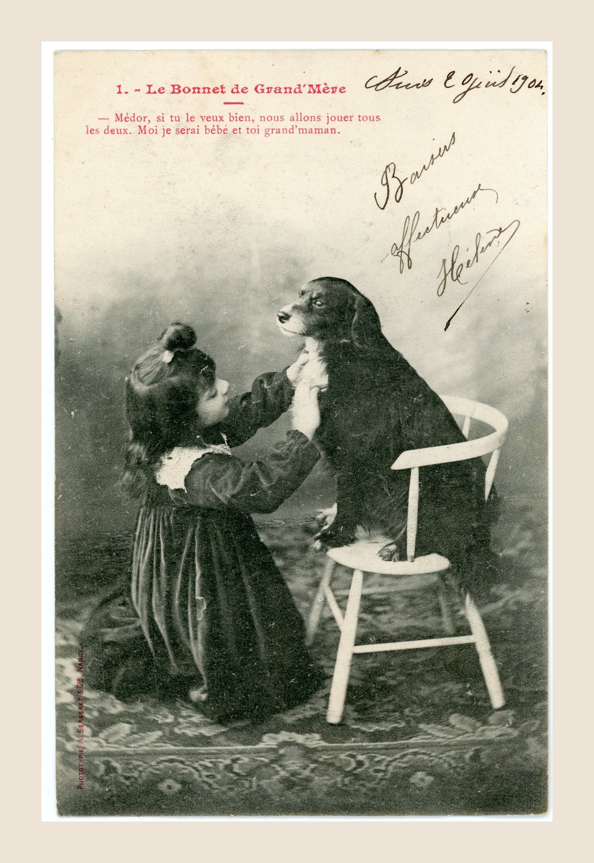 Albert Bergeret Le Bonnet de Grand'Mère antique French postcard number 1 showing a little Belle Époque girl playing with her dog Médor seated on a chair, circa 1904