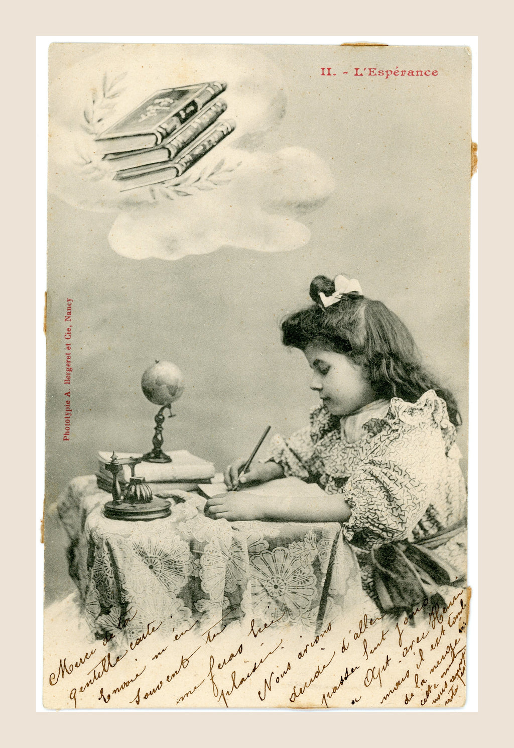 Antique Albert Bergeret postcard No. II L'Espérance showing a young girl writing at a desk with books, globe and inkstand, French Belle Époque circa 1903.