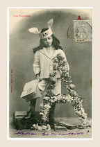 Antique French Bergeret postcard Les Voyelles, letter A for Âne, showing a young girl in a donkey-ear bonnet with books and floral decoration, circa 1905.