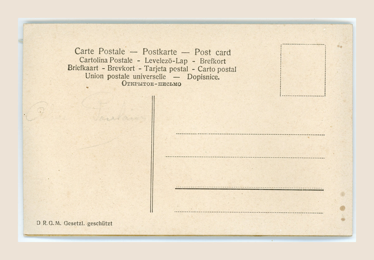Reverse of an antique postcard with multilingual headings, address lines, faint pencil writing, scattered brown spots and age-toned edges.