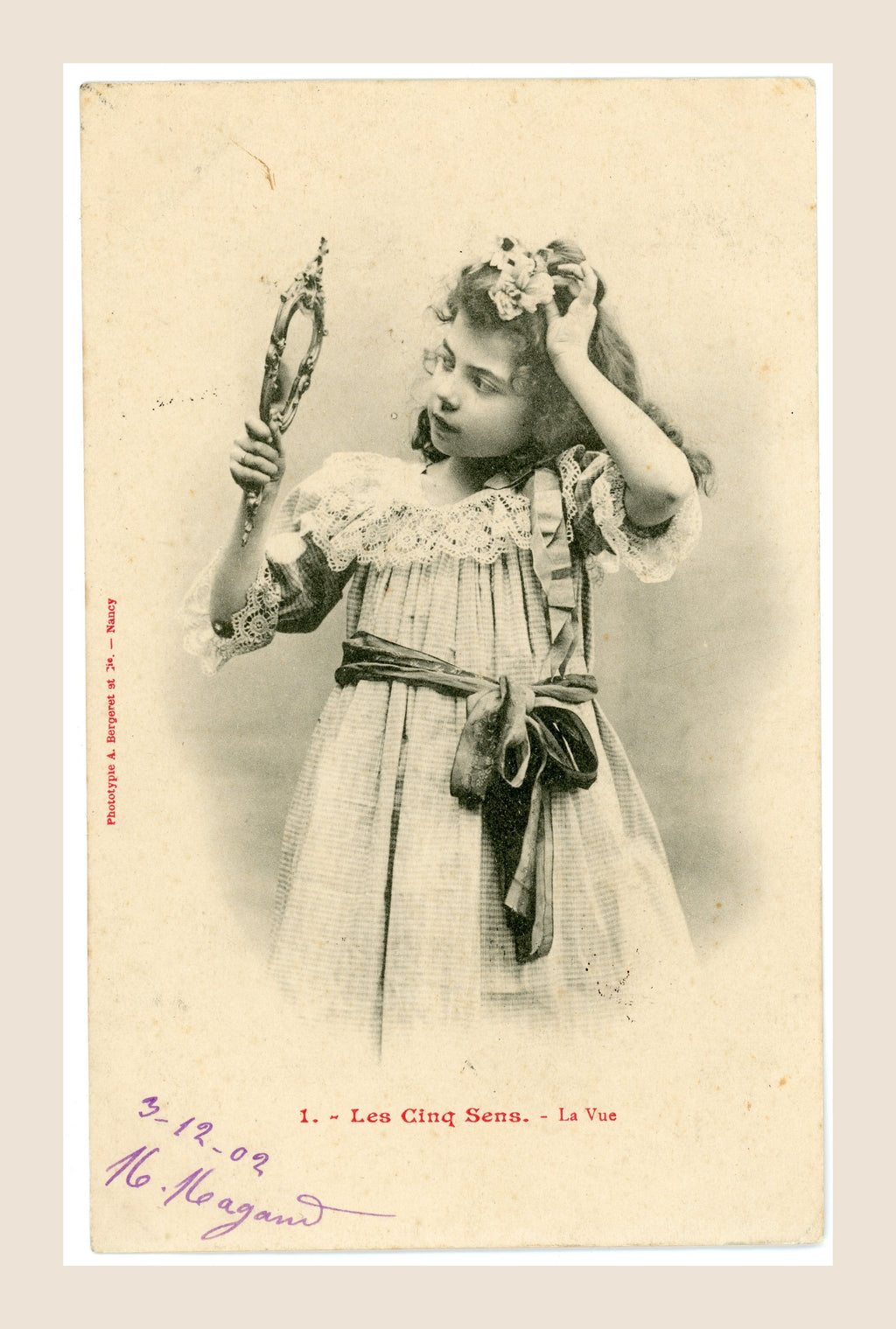 Albert Bergeret Les Cinq Sens La Vue antique French postcard depicting a young Belle Époque girl looking into an ornate handheld mirror.