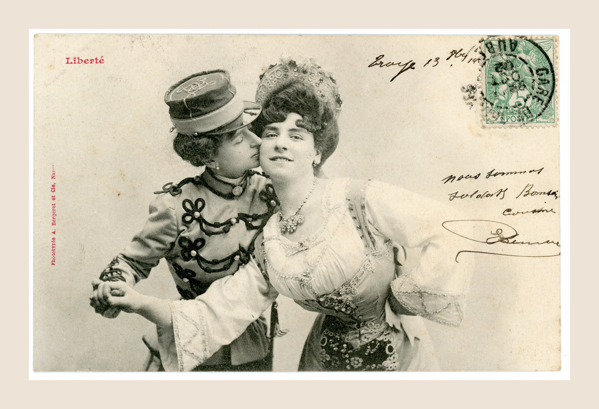 Antique A. Bergeret Liberté French postcard featuring a woman in decorative military uniform kissing another woman on the cheek, Belle Époque 1902.