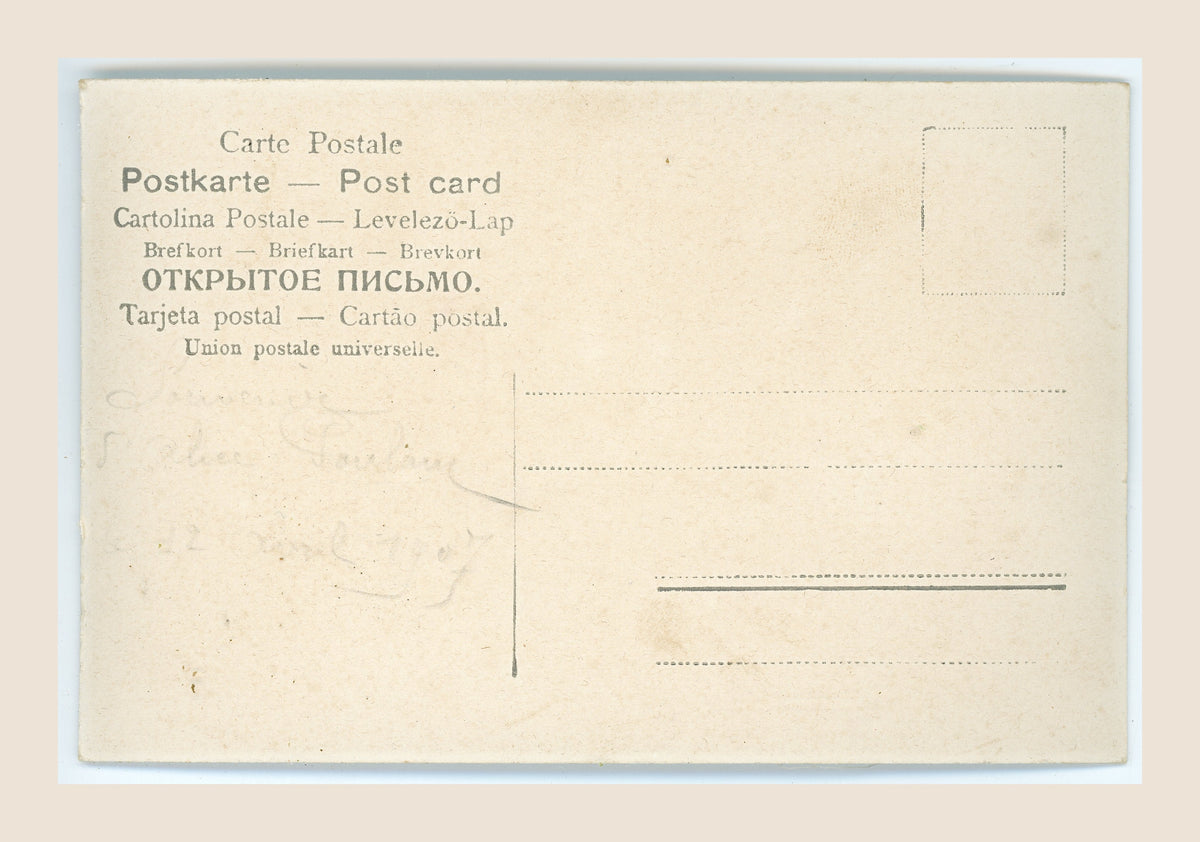 Reverse of an antique postcard with multilingual postal headings, faint pencil writing, address lines, a blank stamp box and age-related spotting.