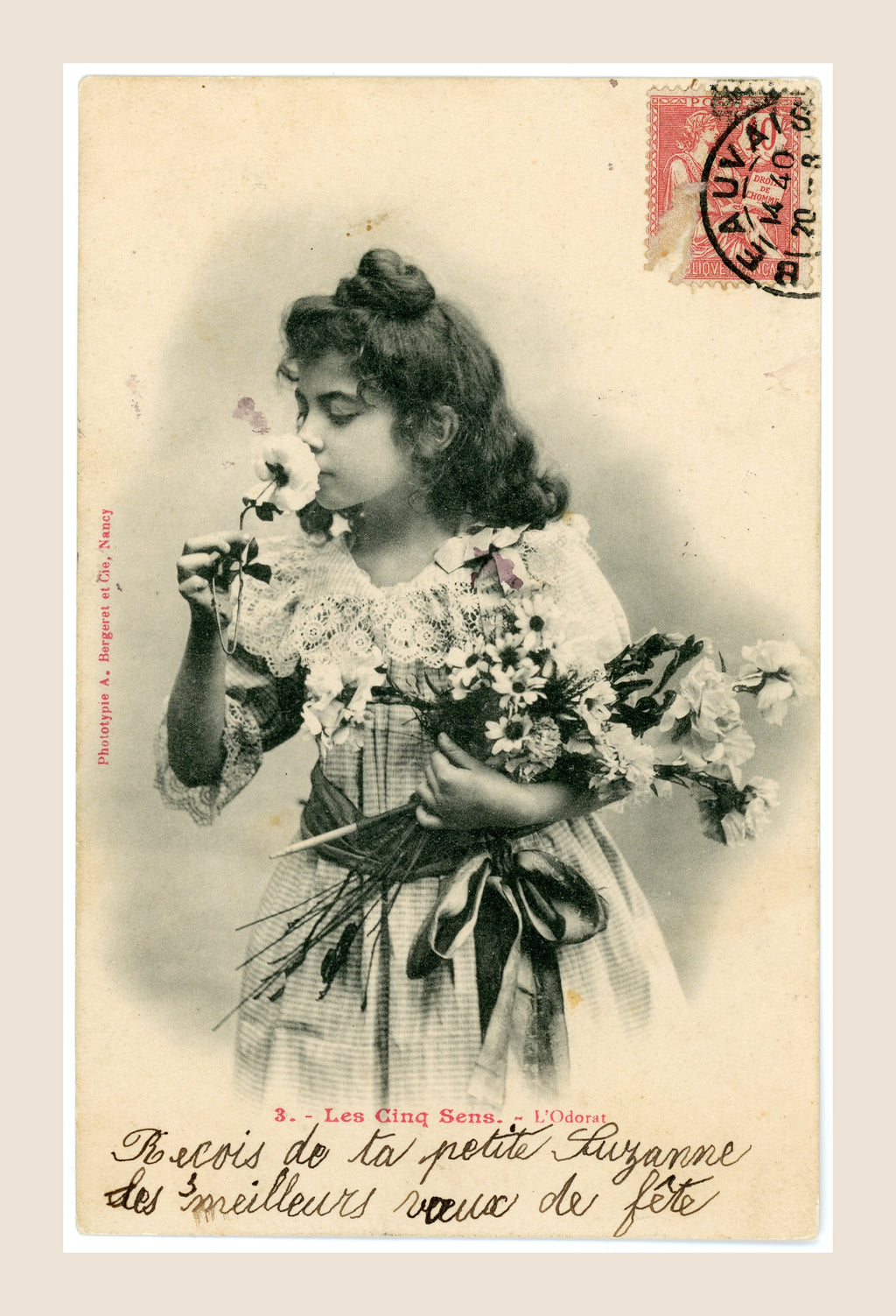 Antique Bergeret Les Cinq Sens L'Odorat postcard showing a young girl smelling a rose and holding flowers, with red French postage stamp.