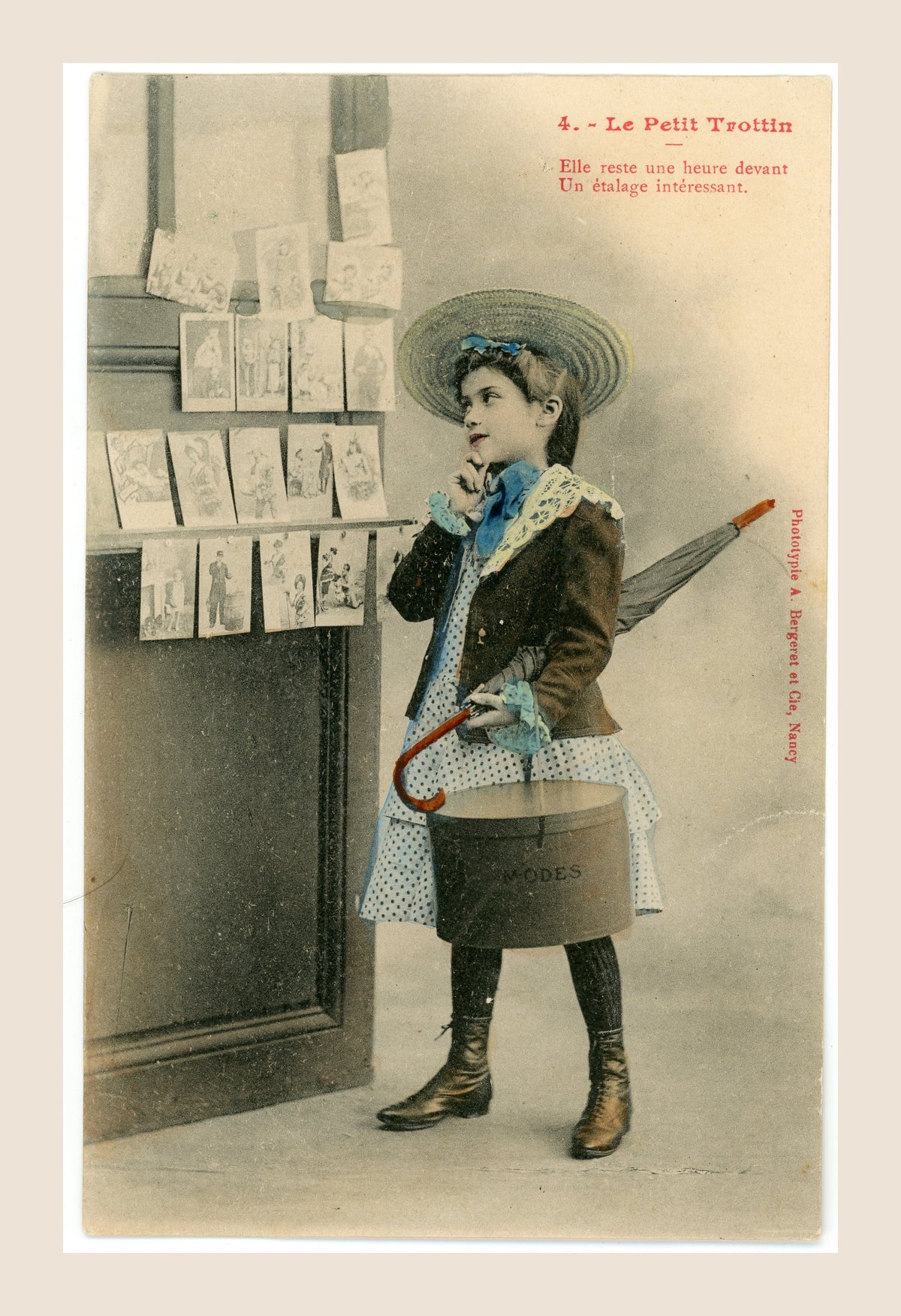 Original Bergeret Le Petit Trottin postcard number 4 depicting a young French fashion messenger admiring an antique postcard shop window.