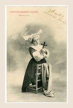 Albert Bergeret Petites Bonnes Sœurs Fervente Prière antique postcard depicting a young girl in a nun costume holding a crucifix beside a draped wooden chair.