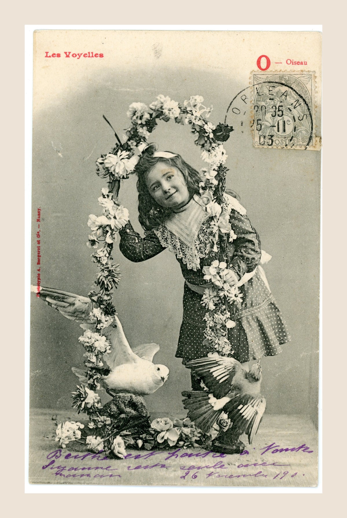 Antique French Les Voyelles letter O postcard by Bergeret, featuring a young girl with birds and a circular floral garland, Belle Époque.