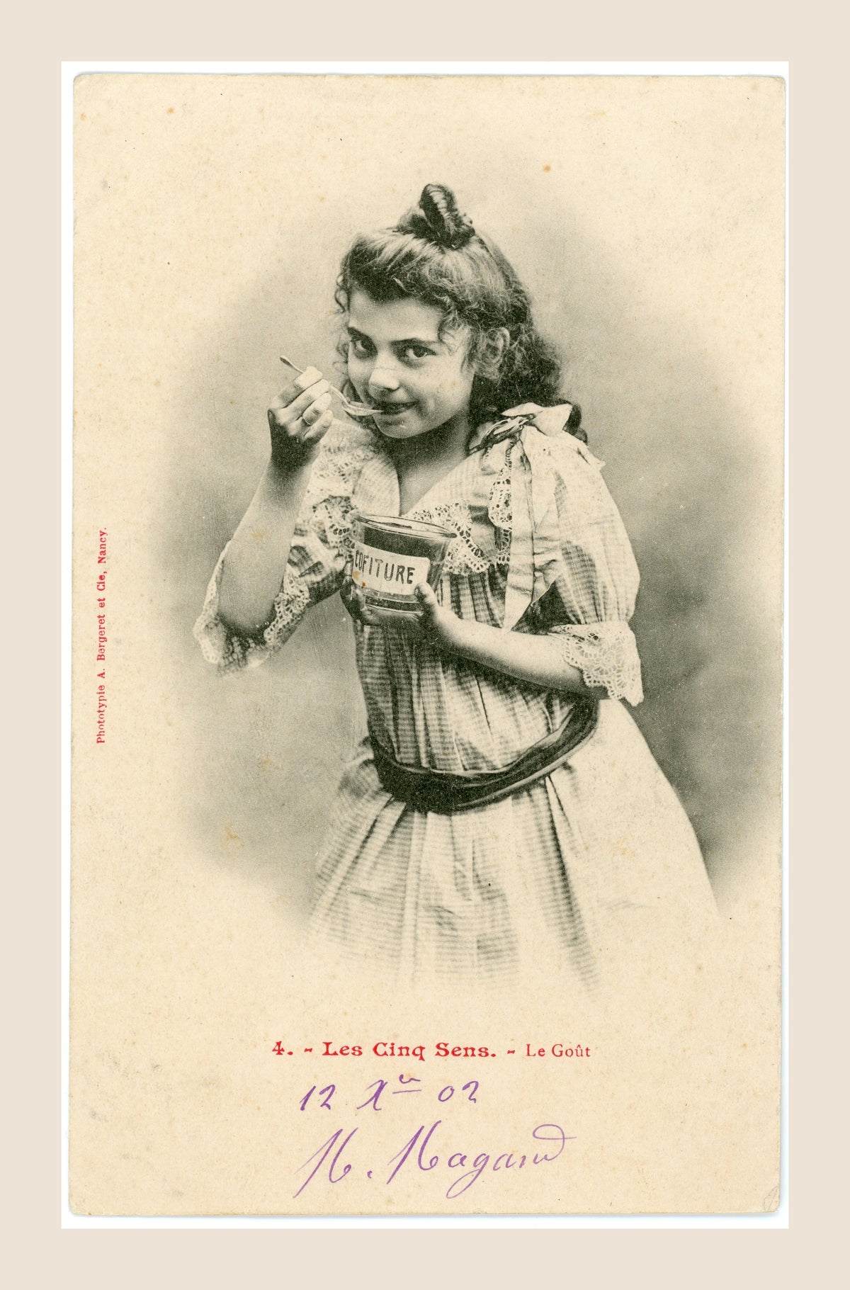 Antique Bergeret Les Cinq Sens Le Goût postcard depicting a Belle Époque girl eating jam from a Confiture jar with a spoon, circa 1903.