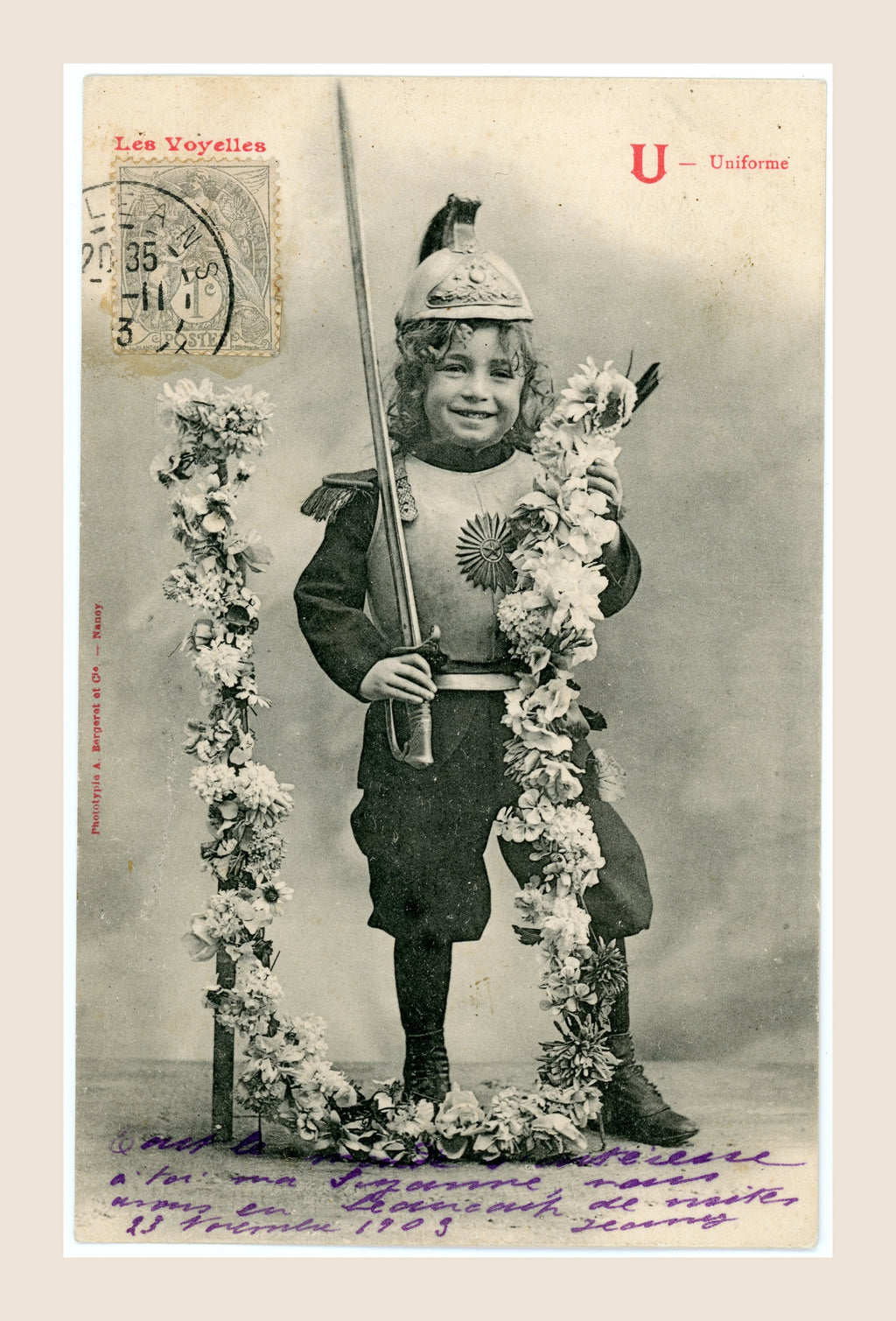 Antique Bergeret Les Voyelles postcard, letter U for Uniforme, depicting a smiling girl in theatrical military costume holding a sword beside floral decorations.