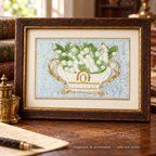 Antique lily of the valley postcard with a white and gold jardinière on pale blue textile, displayed in a patinated wooden frame on a vintage writing desk. Frame not included.