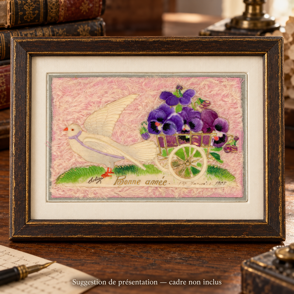 1907 New Year postcard with a white dove and purple fabric pansies on a pink textile background, displayed in a wooden frame. Frame not included.