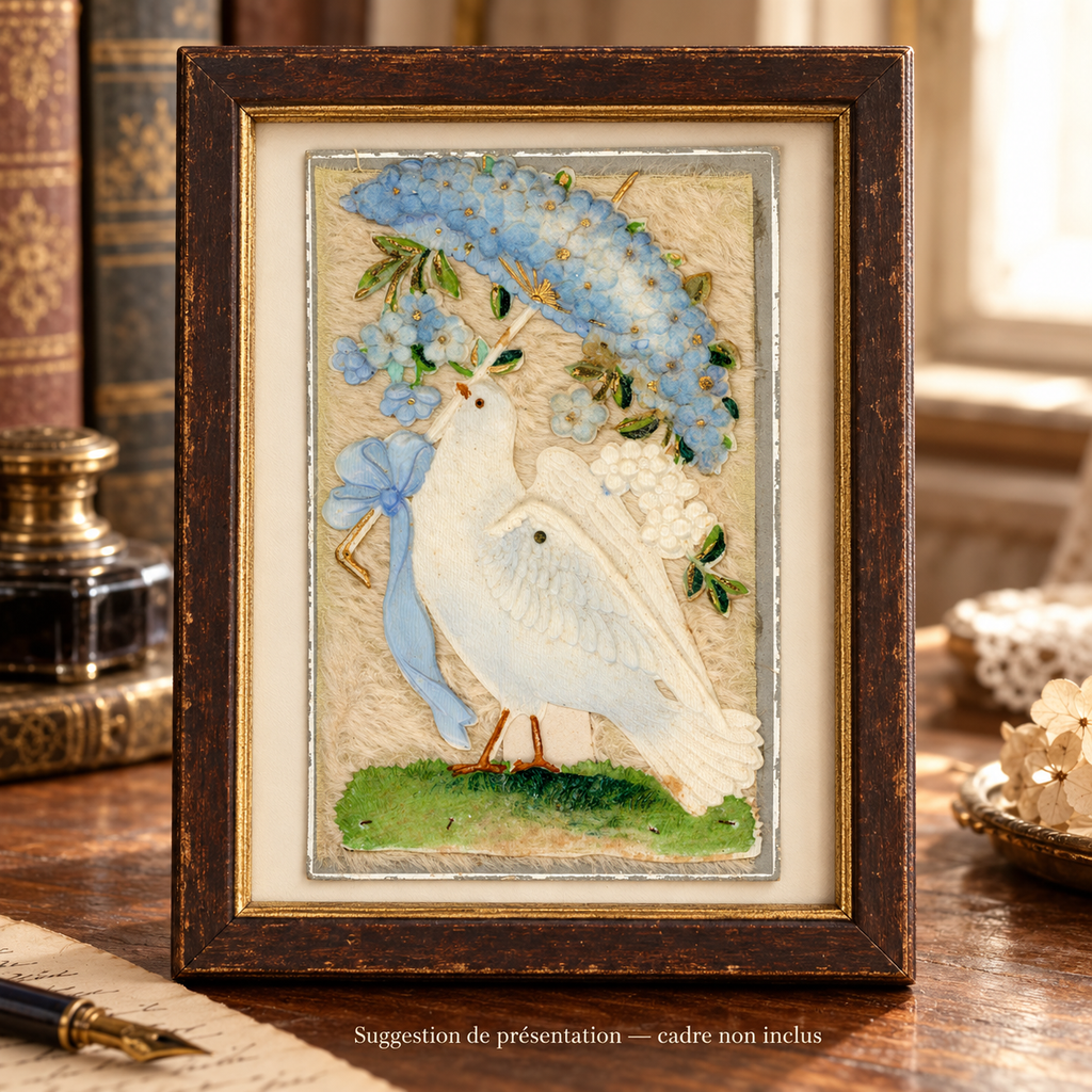 Antique postcard featuring a white dove beneath a blue fabric flower parasol on cream textile, displayed in a patinated wooden frame on a vintage writing desk. Frame not included.