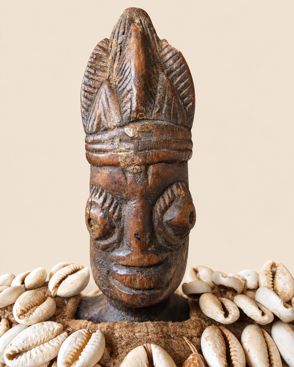 Close-up of carved wooden face and tall coiffure of Yoruba female Ere Ibeji figure from Nigeria