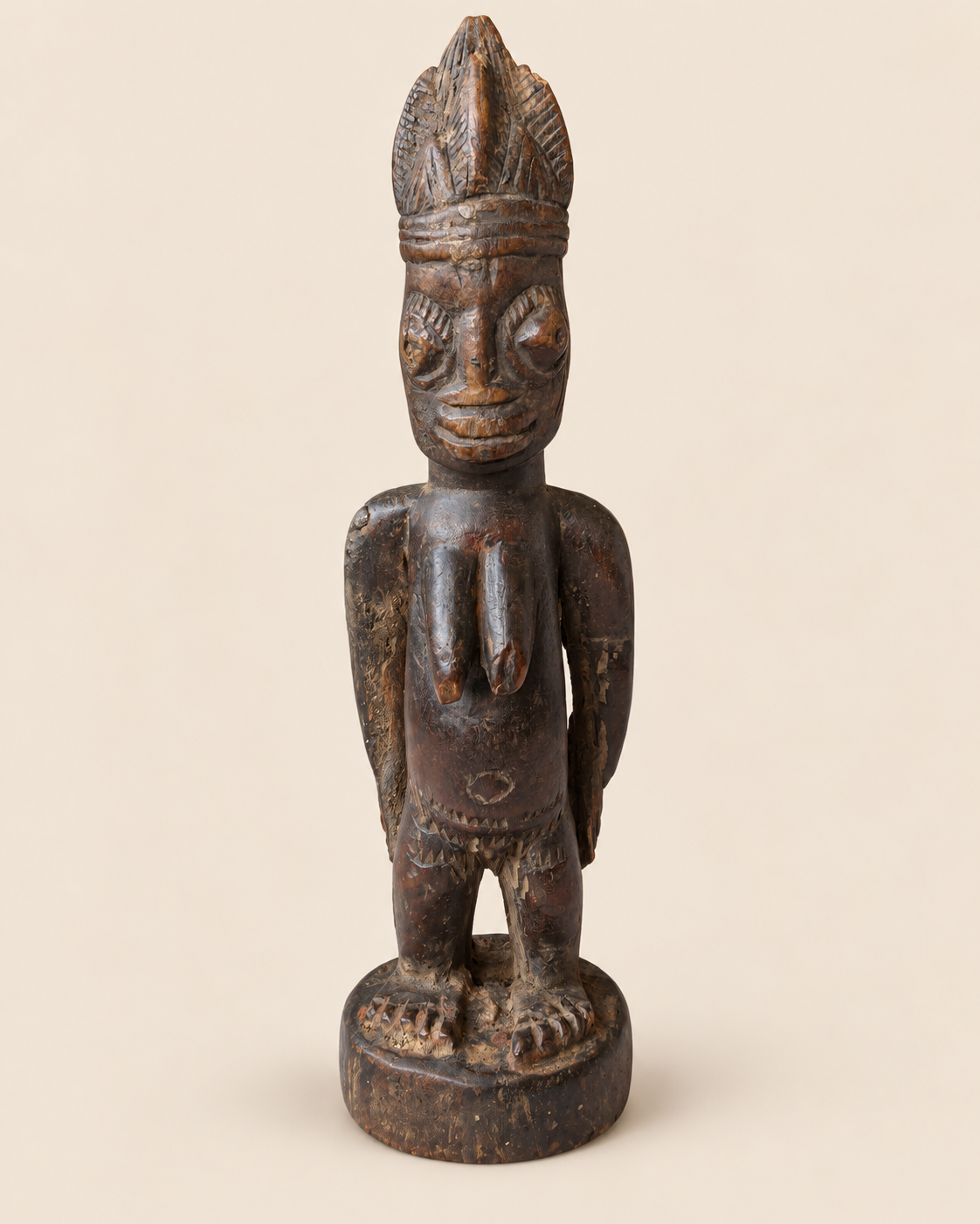 Full front view of Yoruba female Ere Ibeji wooden figure without cowrie cloak, showing carved body and base
