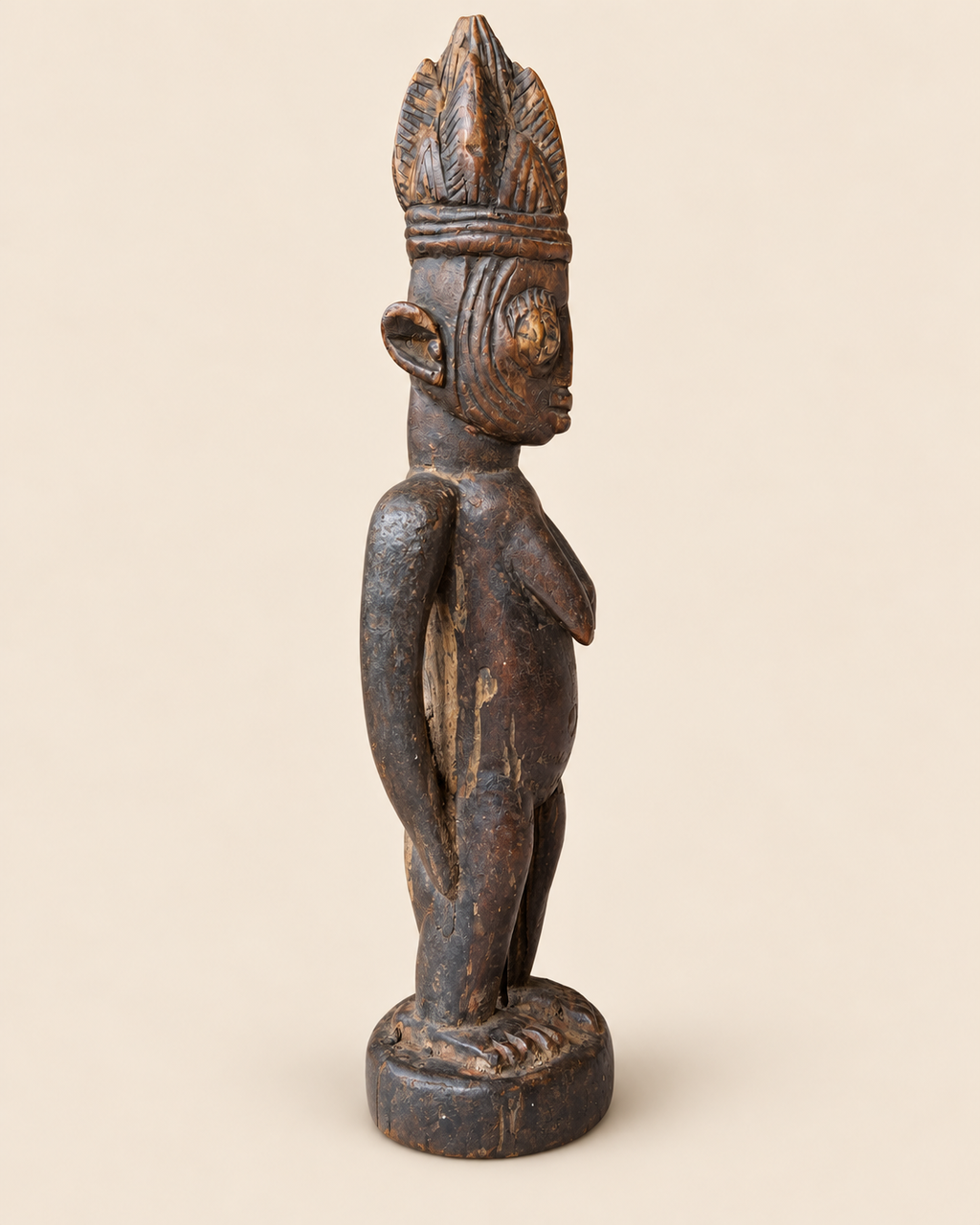 1. Side profile of Yoruba female Ere Ibeji wooden sculpture without cloak, showing carving, patina and age wear