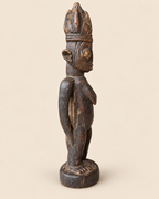 1. Side profile of Yoruba female Ere Ibeji wooden sculpture without cloak, showing carving, patina and age wear