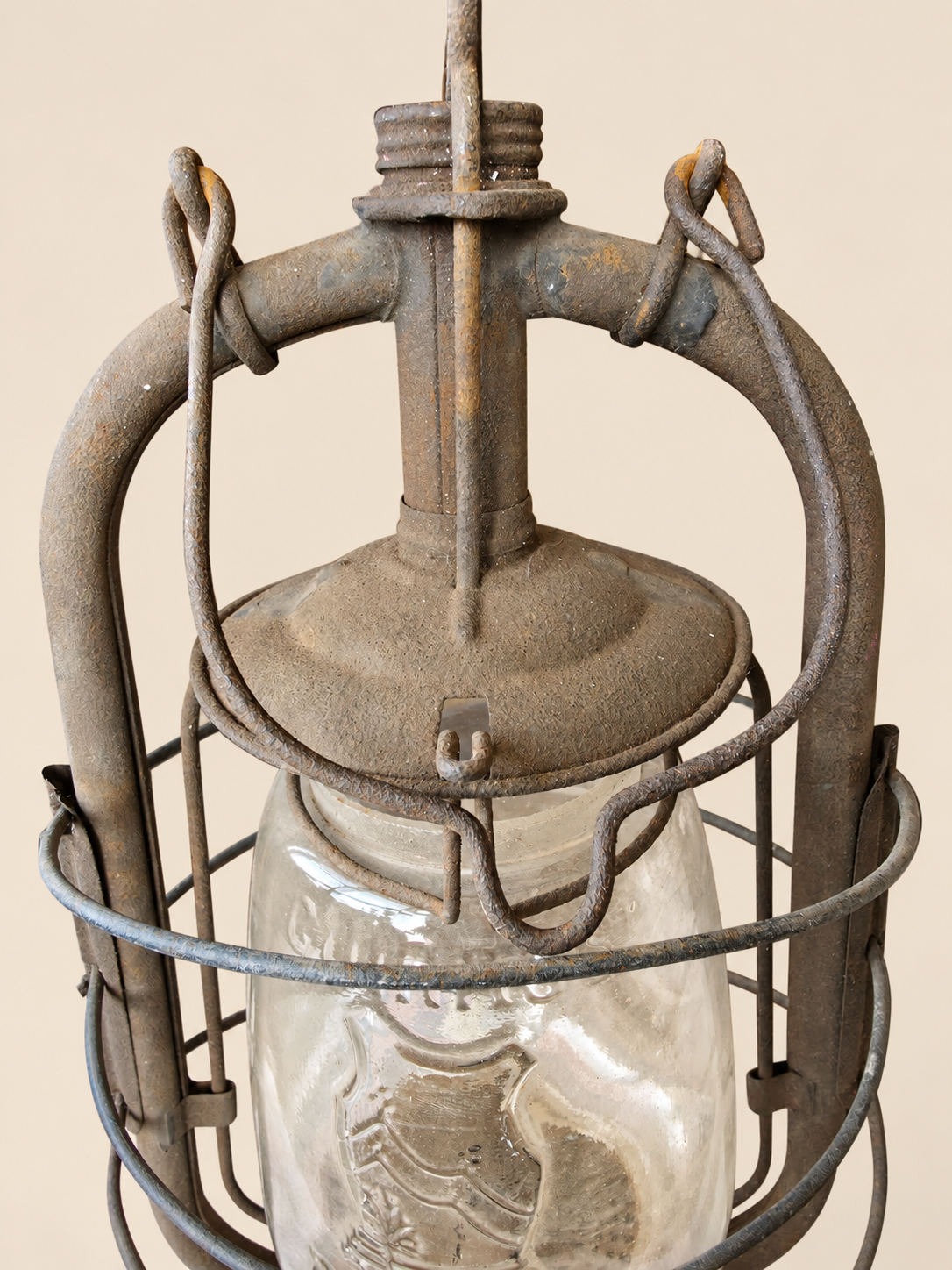 Close-up of the Panzer lantern’s metal chimney, folded carrying handle and upper glass globe, showing rust and age-related wear.