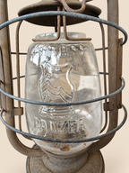 Close-up of the glass globe with raised Cuirass Panzer lettering and armour emblem behind the lantern’s protective metal wires.